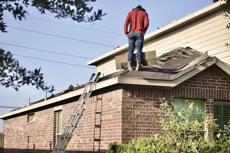 Professional roofer working on a residential roof in Cold Spring Harbor